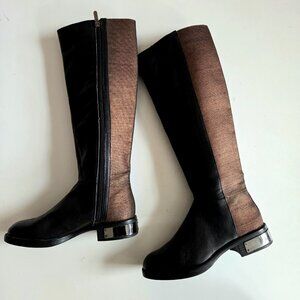 Circus by Sam Adelman black tall flat boots with bronze color elastic details.